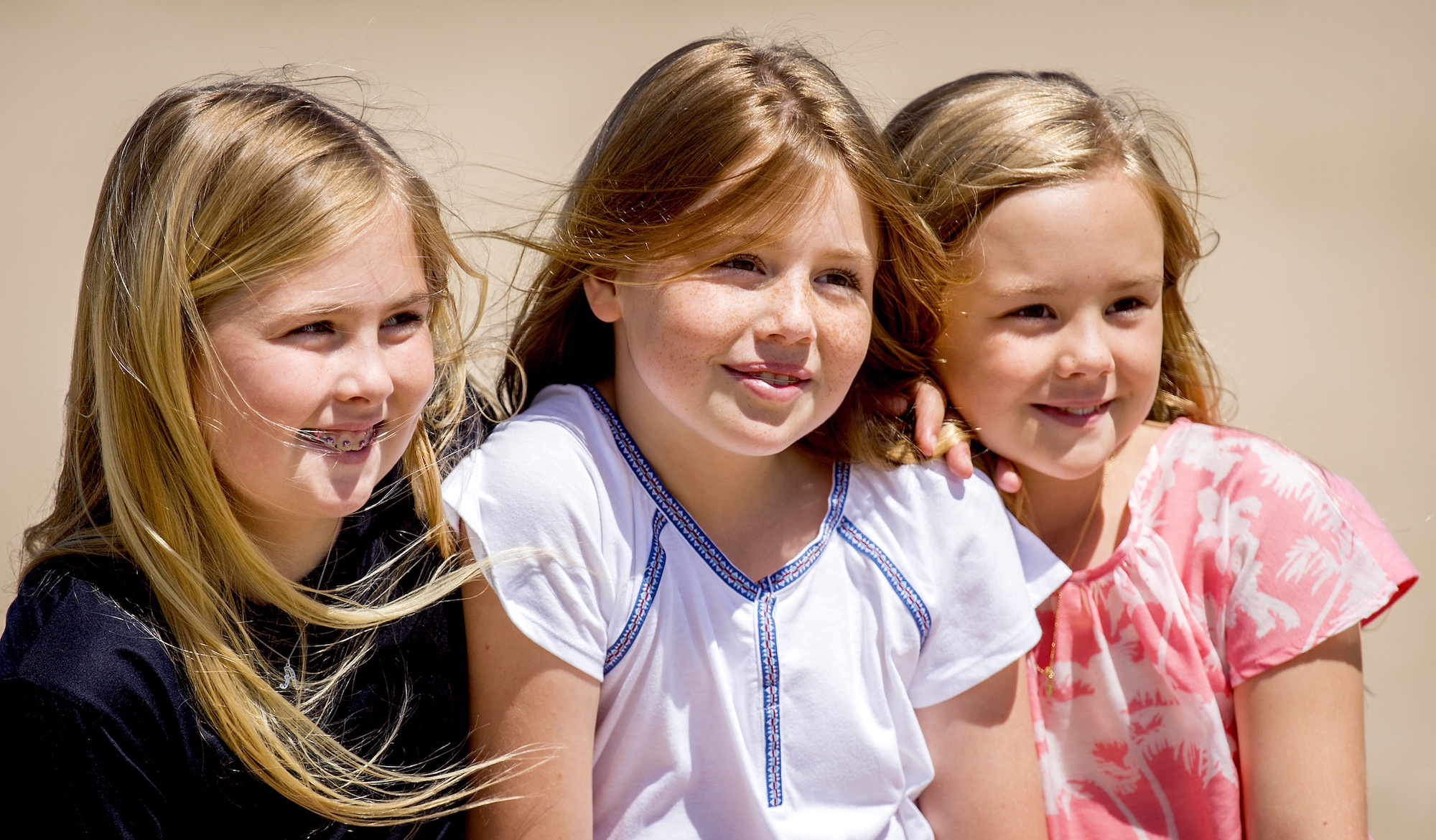 The three sisters pose on the beach for the summer photo session in 2015.