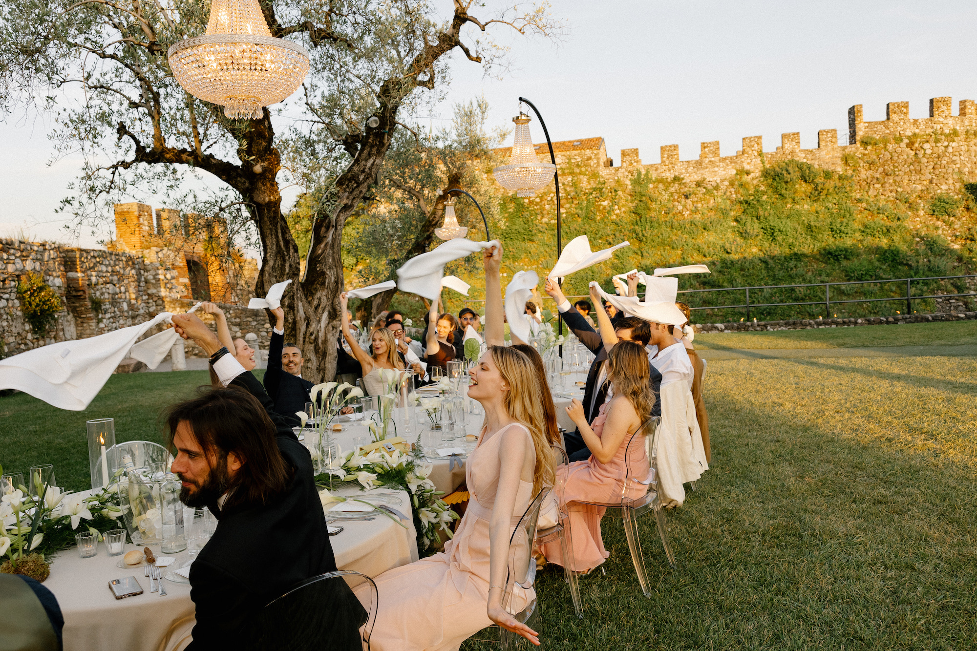 De gasten zwaaien met servetten tijdens het diner