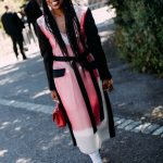 Een gast van New York Fashion Week draagt zwarte sneakers