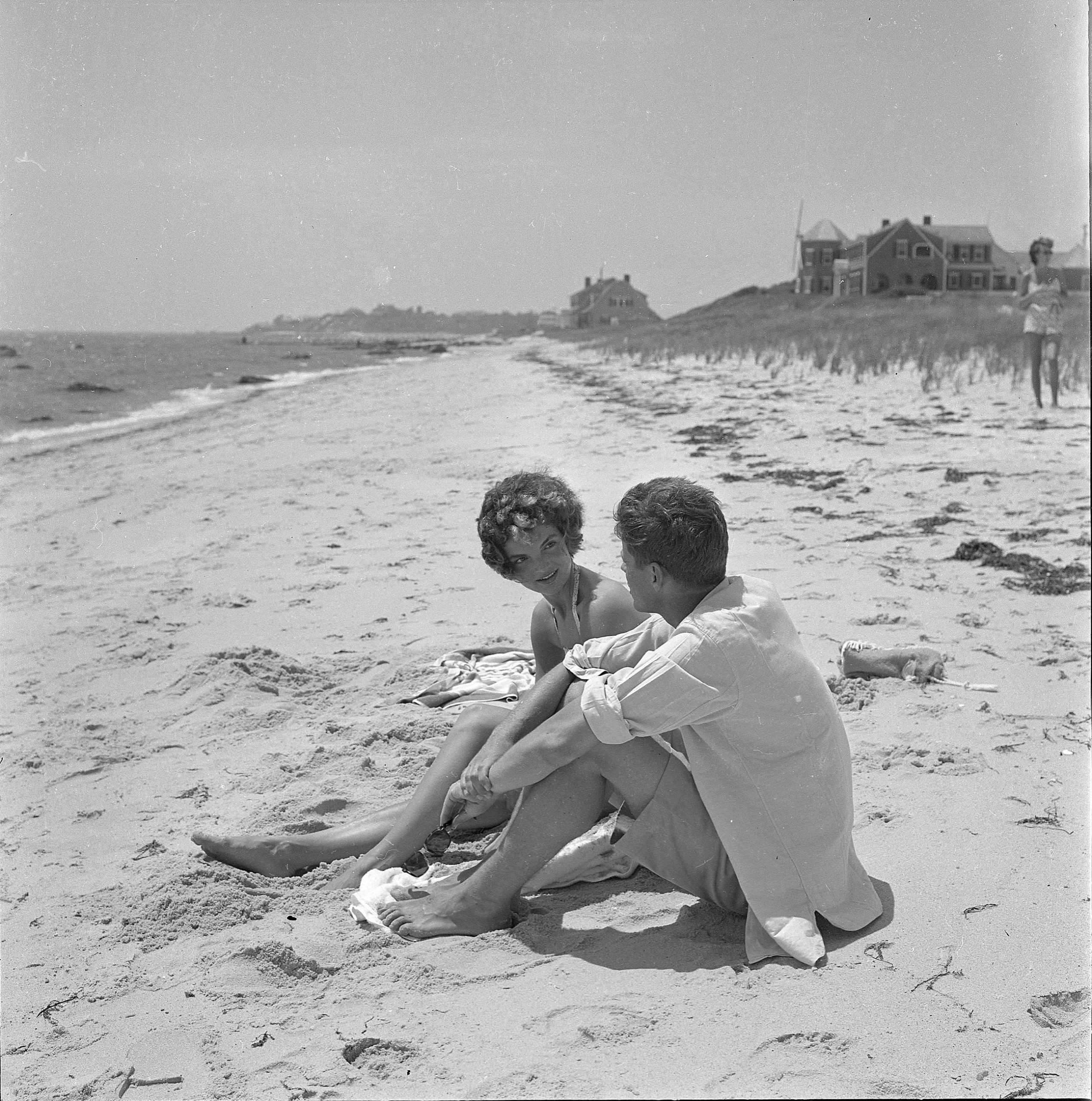 John en Jackie praten op het strand.