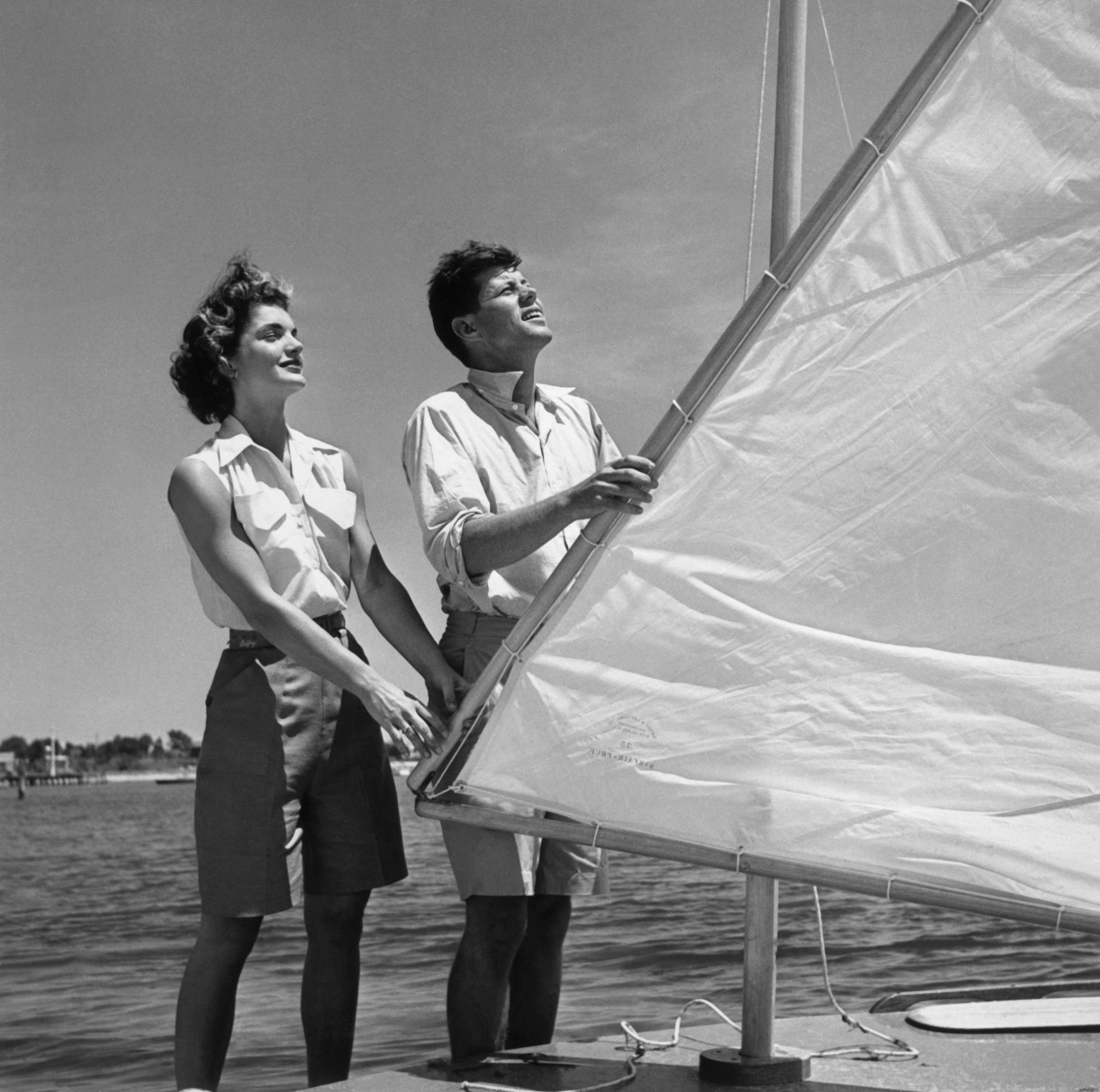 John F Kennedy en Jackie Kennedy stellen het tuig van een kleine boot af.