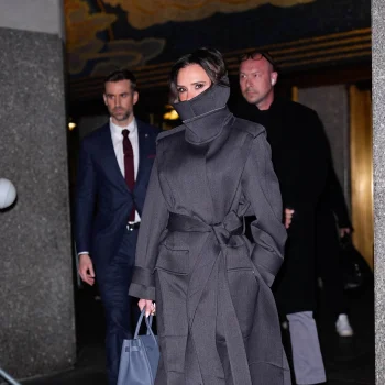 victoria-beckham-verhult-haar-glimlach-zoals-alleen-zij-dat-kan-in-een-stijlvolle-trenchcoat-met-hoge-kraag-376379
